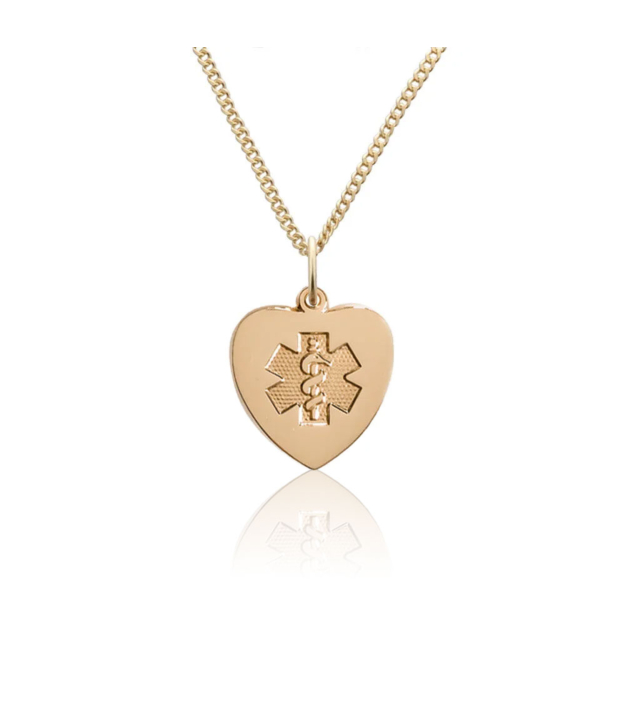 Heart-shaped gold pendant with embossed medical emblem