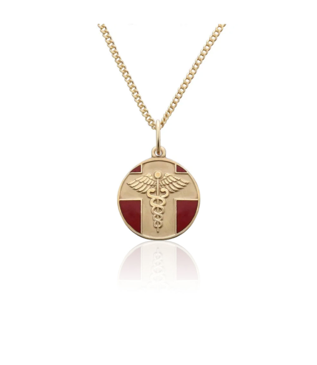 detail of gold and red, round, embossed, and vintage style medical id pendant on chain