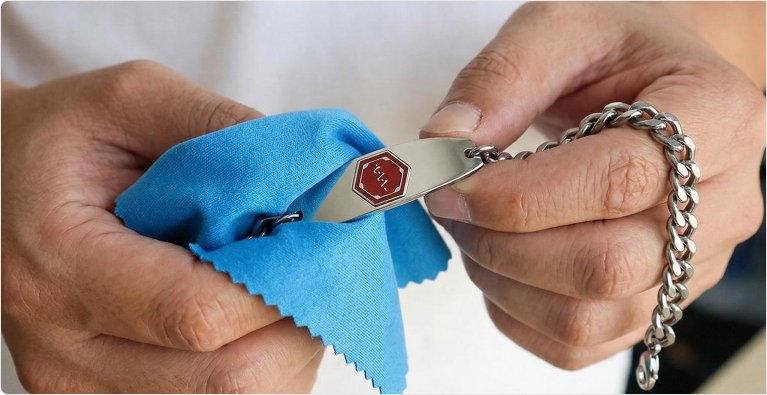 Cleaning a medical ID bracelet with a polishing cloth